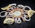 Hollandse Nieuwe- Traditional Dutch Food. Soused raw Herring soaked in mild marinade. Garnished with Lemon, Onion and Parsley Royalty Free Stock Photo