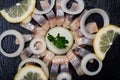 Hollandse Nieuwe- Traditional Dutch Food. Soused raw Herring soaked in mild marinade. Garnished with Lemon, Onion and Parsley Royalty Free Stock Photo