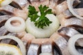 Hollandse Nieuwe- Traditional Dutch Food. Soused raw Herring soaked in mild marinade. Garnished with Lemon, Onion and Parsley Royalty Free Stock Photo