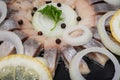 Hollandse Nieuwe- Traditional Dutch Food. Soused raw Herring soaked in mild marinade. Garnished with Lemon, Onion and Parsley Royalty Free Stock Photo