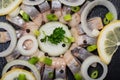 Hollandse Nieuwe- Traditional Dutch Food. Soused raw Herring soaked in mild marinade. Garnished with Lemon, Onion and Parsley Royalty Free Stock Photo