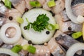 Hollandse Nieuwe- Traditional Dutch Food. Soused raw Herring soaked in mild marinade. Garnished with Lemon, Onion and Parsley Royalty Free Stock Photo