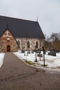 View of the medieval, stone Church, Hollolan Kirkko, with cemetery, Hollola, Finland.