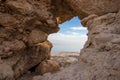 Hollow rock in Ein Gedi, in the background of the palm groves,