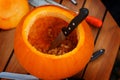 Hollowing out a pumpkin to prepare halloween lantern Royalty Free Stock Photo