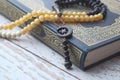 Holly Quran with beads on white background , close up