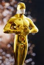 Hollywood Golden Oscar Academy award statue in medical mask. Success and victory concept. Oscar ceremony in coronavirus time