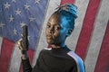 Hollywood movie style portrait of young attractive and confident black African American woman holding gun as special federal agent