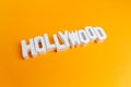 Hollywood wooden words in a orange background Royalty Free Stock Photo