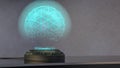 A holo projector projects a shimmering blue sphere