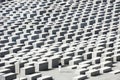 Holocaust Memorial Berlin - Memorial for the Murdered Jews - lonly woman between concrete slabs Royalty Free Stock Photo