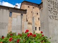 The Holocaust memorial with written stele and green grass and roses