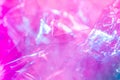 Holographic background in the style of the 80-90s. Real texture of cellophane film in bright acid colors. Royalty Free Stock Photo