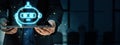 Holographic chatbot icon displayed above a tablet held by a businessman in a dark office setting