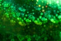 Holographic  green background with abstract colorful blur stars shaped bokeh Royalty Free Stock Photo