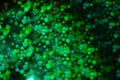 Holographic  green background with abstract colorful blur stars shaped bokeh Royalty Free Stock Photo