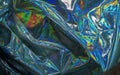 Holographic iridescent foil texture background. Futuristic vibrant neon trendy mermaid silver colors