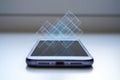 Holographic projection emanating from modern smartphone screen, abstract digital data visualization, futuristic technology concept Royalty Free Stock Photo