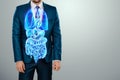 A holographic projection of a scan of human internal organs inside the body of a man in a suit. The concept of modern medicine,