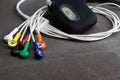 Holter, medical device for a heart rate measurement with all the colorful cables on industrial gray background