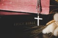 Holy bible book with cross or crucifix on old black wooden background. Christian catholic with protestant pray and study in church Royalty Free Stock Photo