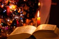 Holy Bible with candle on bokeh Royalty Free Stock Photo