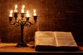 Holy Bible and candle on a old oak wooden table. Royalty Free Stock Photo