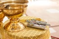 Holy Bible, cross, bowl on table in church ready for ceremony. close up. Royalty Free Stock Photo