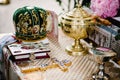 Holy Bible, crown, cross, bowl, crown  on table in church ready for ceremony. close up Royalty Free Stock Photo