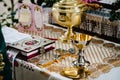 Holy Bible, crown, cross, bowl, crown on table in church ready for ceremony. close up Royalty Free Stock Photo