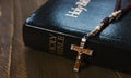 Holy Bible with crucifix on wooden table Royalty Free Stock Photo