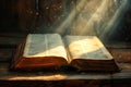 Holy Bible is an open book on which golden rays of light fall from above. Royalty Free Stock Photo