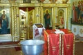 Holy Bible, Orthodox cross and Bowl prepared for christening ceremony Royalty Free Stock Photo