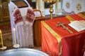 Holy Bible, Orthodox cross and Bowl prepared for christening ceremony Royalty Free Stock Photo