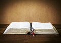 The holy bible and the red cross over on wooden table Royalty Free Stock Photo