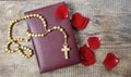 Holy Bible, rosary and red rose petals Royalty Free Stock Photo