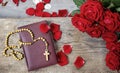 Holy Bible, rosary and red rose petals Royalty Free Stock Photo