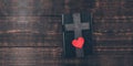 Holy Bible. On the table. Cross crucifix and red heart. The concept of God\'s love. On a wooden background. Royalty Free Stock Photo