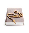 Holy bible and wooden rosary beads isolated on white background Royalty Free Stock Photo