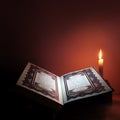 Holy book of Islam with candle light. Royalty Free Stock Photo