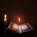 Holy book of Islam with candle light. Royalty Free Stock Photo