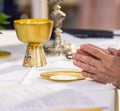 The hands of the Pope consecrate the host, the holy bread in the Royalty Free Stock Photo