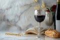 In this Holy Communion concept, the chalice of wine is accompanied by bread and the Bible on a light background. Royalty Free Stock Photo