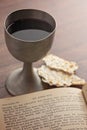 A Holy Communion in a Pewter Goblet with an Antique Bible Royalty Free Stock Photo