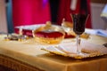 Holy communion wine glass and bread during wedding traditional ceremony in church Royalty Free Stock Photo