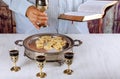Holy communion on wooden table in church cup of glass with red wine, bread, prayer for wine Royalty Free Stock Photo