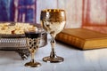 Holy communion on wooden table on church. Cup of glass with red wine, bread on wooden table. Holy Bible