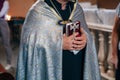 The Holy Cross in the hands of a priest, close up