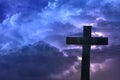 Holy cross under a blue stormy sky