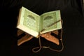 Holy islamic book Koran opened with rosary